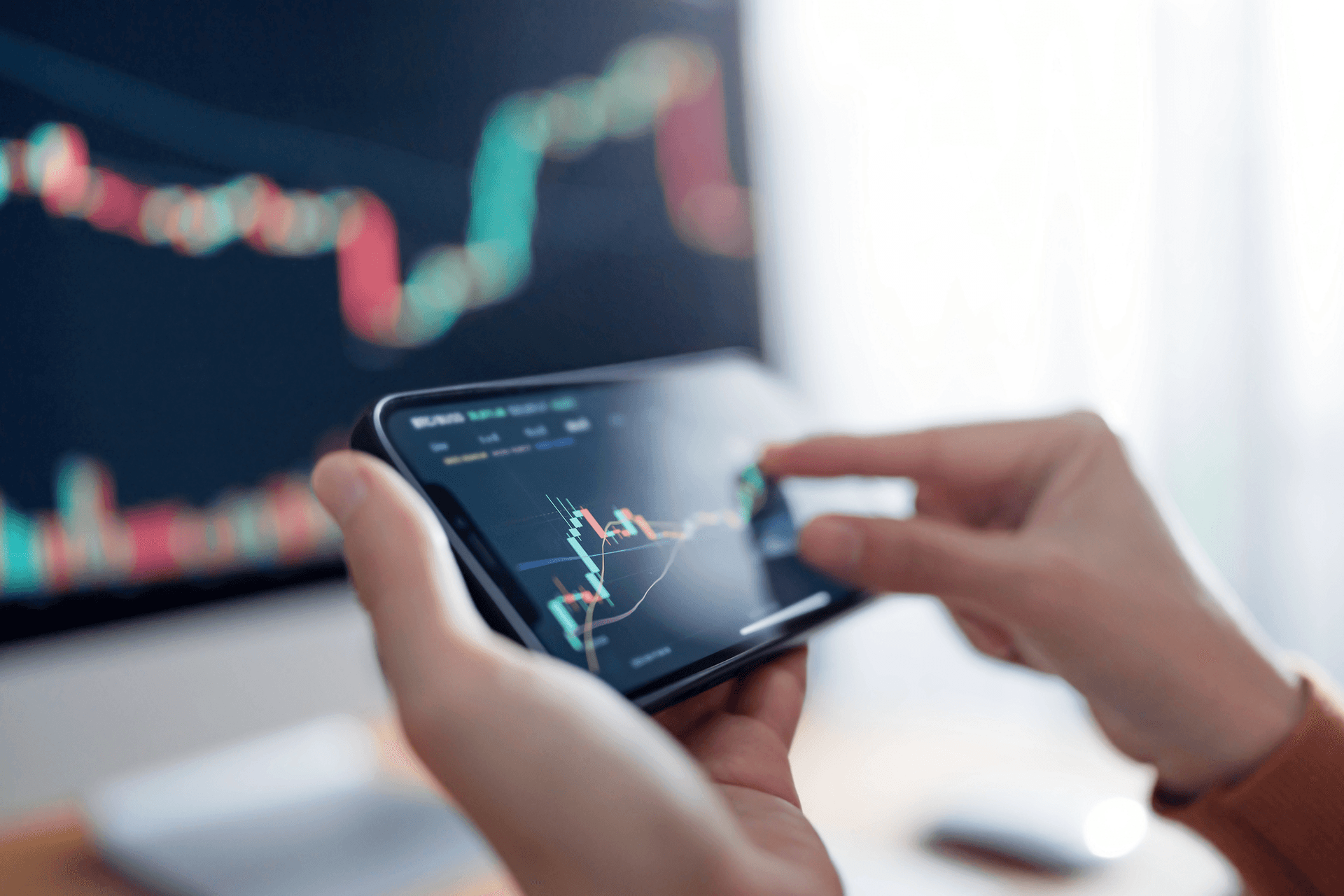 A woman checks the price chart on a digital exchange on her smartphone